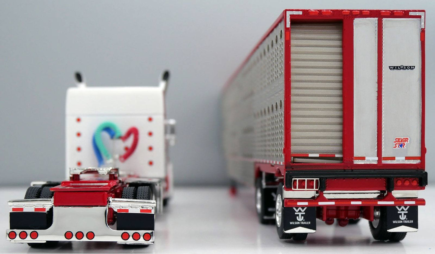 1:64 DCP White red and burgundy Peterbilt 379 with Wilson Spread Axle Cattle Trailer